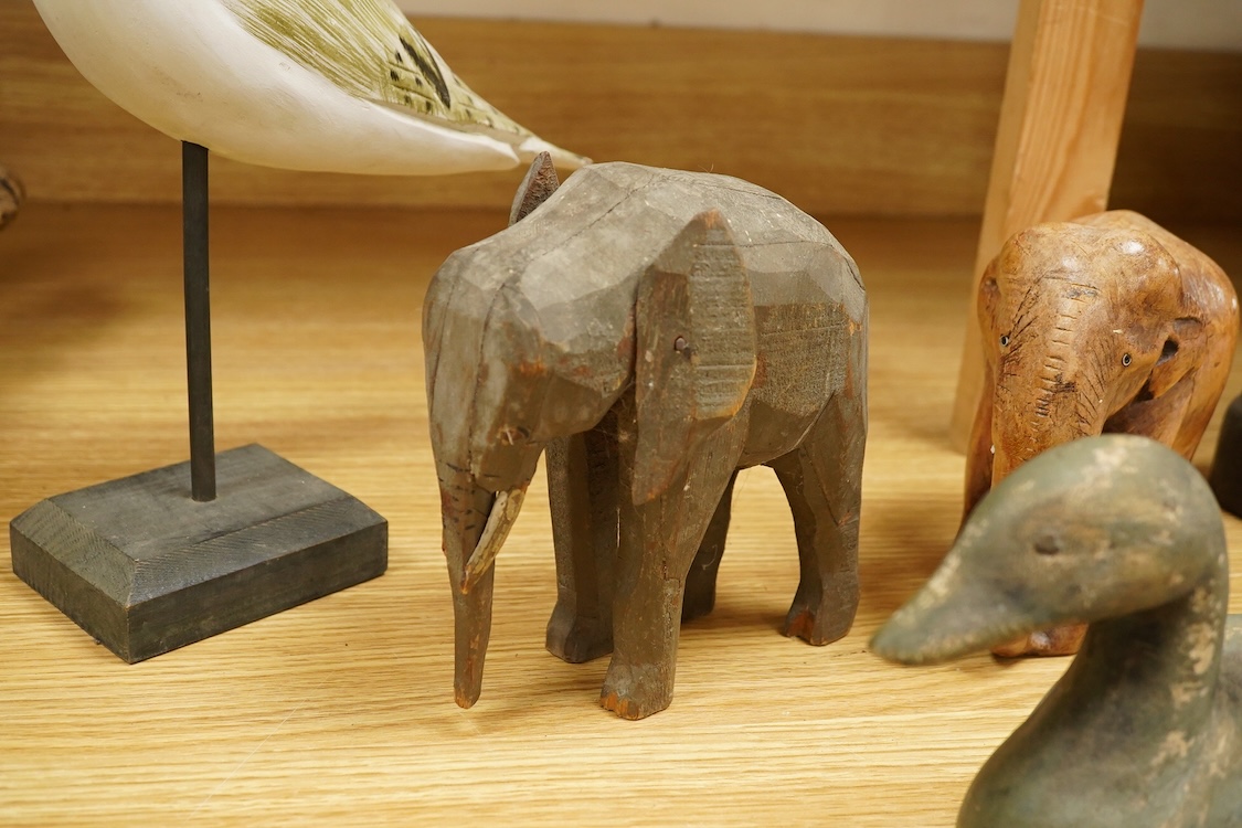 A carved and painted decoy duck, two carved elephants and two other painted birds, tallest 41cm